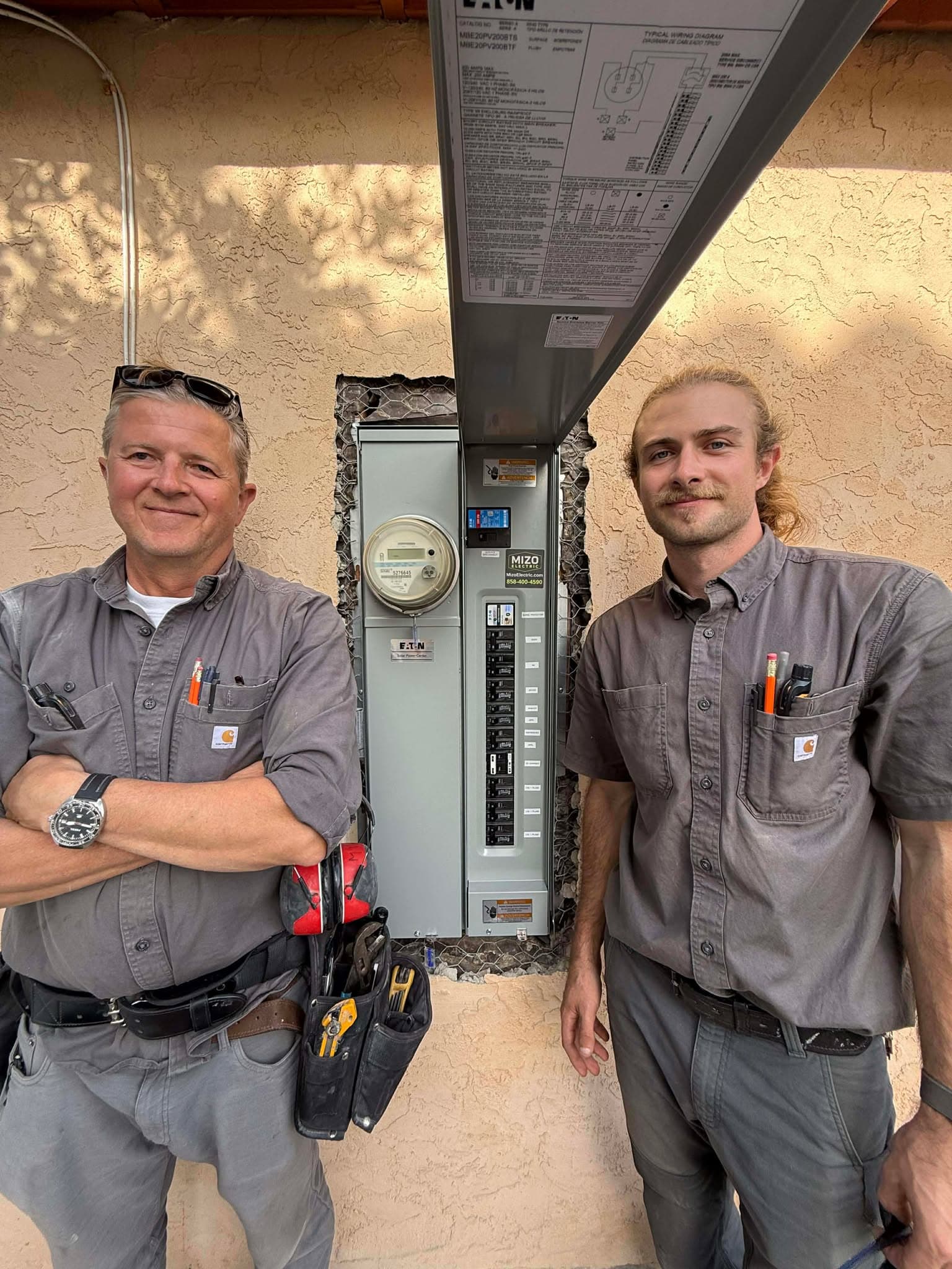 Miro and Michael Popovic after completing an electrical panel upgrade